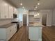 A modern kitchen features white cabinets, stainless steel appliances, and a granite island at 5311 Tuscany Dr # 98 Plapprox Sqft, Douglasville, GA 30135