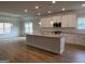 A modern kitchen features white cabinets, stainless steel appliances, and a granite island at 5311 Tuscany Dr # 98 Plapprox Sqft, Douglasville, GA 30135