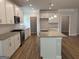 A modern kitchen features white cabinets, stainless steel appliances, and a granite island at 5311 Tuscany Dr # 98 Plapprox Sqft, Douglasville, GA 30135