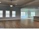 Spacious living room with a ceiling fan, wood floors, and plenty of natural light at 5311 Tuscany Dr # 98 Plapprox Sqft, Douglasville, GA 30135