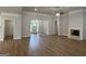 Spacious living room featuring wood floors, a cozy fireplace, and ample natural light from the front entrance at 5311 Tuscany Dr # 98 Plapprox Sqft, Douglasville, GA 30135