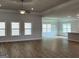 Spacious living room with a ceiling fan, wood floors, and plenty of natural light at 5311 Tuscany Dr # 98 Plapprox Sqft, Douglasville, GA 30135