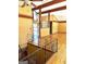 Open entryway featuring hardwood floors, modern railing and chandelier at 2555 Rockbridge Nw Rd, Conyers, GA 30012