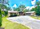 Charming single-story brick home featuring a large driveway and beautiful landscaping at 2555 Rockbridge Nw Rd, Conyers, GA 30012