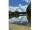 Scenic view of the lake with trees and sky reflections at 2555 Rockbridge Nw Rd, Conyers, GA 30012