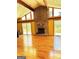 Spacious living room with a stone fireplace, vaulted ceilings, and wood floors at 2555 Rockbridge Nw Rd, Conyers, GA 30012