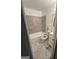 Bathroom with a bathtub and shower featuring grey tiled walls and white fixtures at 1721 Lisbon Sw Dr, Atlanta, GA 30310