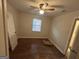 Bedroom featuring hardwood floors, ceiling fan with light, and a bright window at 1721 Lisbon Sw Dr, Atlanta, GA 30310