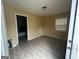 A bedroom offers modern wood-look flooring, a window letting in natural light, and a ceiling light at 1721 Lisbon Sw Dr, Atlanta, GA 30310