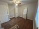 Bedroom showcasing hardwood floors, ceiling fan with light, and a bright window at 1721 Lisbon Sw Dr, Atlanta, GA 30310