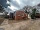 Red brick exterior showcasing the backyard and exterior features at 1721 Lisbon Sw Dr, Atlanta, GA 30310