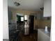 This kitchen features stainless steel refrigerator, gray cabinets and some updates at 1721 Lisbon Sw Dr, Atlanta, GA 30310