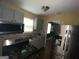 This kitchen features stainless steel refrigerator, gray cabinets, microwave, and gas stove top at 1721 Lisbon Sw Dr, Atlanta, GA 30310