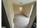 Open living area featuring laminate flooring, natural light, and simple wall decor at 1721 Lisbon Sw Dr, Atlanta, GA 30310