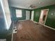A green painted living room with ceiling fan, hardwood floors and door frame views at 1721 Lisbon Sw Dr, Atlanta, GA 30310