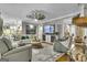 Spacious living room featuring modern decor, stylish seating, and a decorative ceiling fan at 121 Rising Star Rd, Fayetteville, GA 30215