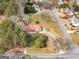 Sprawling property with a charming home featuring a bright red roof nestled among mature trees and lush landscaping at 1713 Bramlett Shoals Rd, Lawrenceville, GA 30045