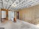 Unfinished basement showing exposed ceiling beams, insulation, and a doorway at 1713 Bramlett Shoals Rd, Lawrenceville, GA 30045