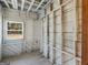 Unfinished room shows wall studs, wood flooring, and exterior window at 1713 Bramlett Shoals Rd, Lawrenceville, GA 30045