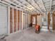 Unfinished basement with brick and wood framework showing doorway and concrete floor at 1713 Bramlett Shoals Rd, Lawrenceville, GA 30045