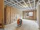 Unfinished basement with exposed insulation and wooden framework and single window at 1713 Bramlett Shoals Rd, Lawrenceville, GA 30045