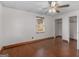Bedroom with hardwood floors, a window, two closets and ceiling fan with a light at 1713 Bramlett Shoals Rd, Lawrenceville, GA 30045