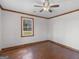 Bedroom featuring a ceiling fan, hardwood floors, wood trim and a window at 1713 Bramlett Shoals Rd, Lawrenceville, GA 30045