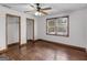 Bedroom with ceiling fan, closet and view out the window at 1713 Bramlett Shoals Rd, Lawrenceville, GA 30045