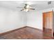 Bedroom featuring hardwood floors, ceiling fan and wooden door at 1713 Bramlett Shoals Rd, Lawrenceville, GA 30045