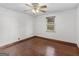 Standard bedroom with hardwood floors, white walls, ceiling fan, and a single window at 1713 Bramlett Shoals Rd, Lawrenceville, GA 30045