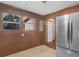 View of the kitchen with wooden panels and a stainless steel refrigerator at 1713 Bramlett Shoals Rd, Lawrenceville, GA 30045