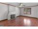 Bright living room featuring hardwood floors, a fireplace, and a window to let the light in at 1713 Bramlett Shoals Rd, Lawrenceville, GA 30045