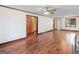 Expansive living room showcasing hardwood floors, a door to another room and neutral wall paint throughout at 1713 Bramlett Shoals Rd, Lawrenceville, GA 30045
