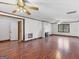 Vast living room featuring hardwood floors, a fireplace, and multiple ceiling fans that provide air circulation at 1713 Bramlett Shoals Rd, Lawrenceville, GA 30045