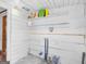 Utility room with white wooden walls and open shelves for storage at 1713 Bramlett Shoals Rd, Lawrenceville, GA 30045