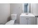 Bathroom featuring a vanity with cabinets, white toilet, and updated mirror at 9090 Dorsey Rd, Riverdale, GA 30274