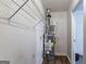 View of the hot water heater with a shelf above in a utility room at 9090 Dorsey Rd, Riverdale, GA 30274