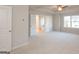 Spacious, carpeted main bedroom with a ceiling fan and ensuite bathroom entryway at 4853 Walkers Green, Mableton, GA 30126