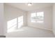 Bright, carpeted bedroom with neutral walls and a large window providing natural light at 4853 Walkers Green, Mableton, GA 30126