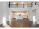 Sun-drenched view of the open-concept living room and kitchen area with hardwood floors at 4853 Walkers Green, Mableton, GA 30126