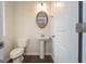Well-lit powder room with wood-look floors and pedestal sink at 4853 Walkers Green, Mableton, GA 30126