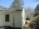 Image shows the siding and window of a home with a tree to the right of the home's exterior at 1989 Grant Sw Rd, Atlanta, GA 30331