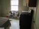 Kitchen view showing a stove, window, table, and cluttered floor at 1989 Grant Sw Rd, Atlanta, GA 30331