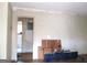 Living room view with an open doorway to another room and debris on the floor from renovations at 1989 Grant Sw Rd, Atlanta, GA 30331