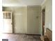 A view of the living room, showing the doorway and the wood floors needing replacement at 1989 Grant Sw Rd, Atlanta, GA 30331