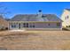 Expansive backyard featuring a well-kept lawn and mature trees, ideal for outdoor activities and relaxation at 227 Lantana Dr, Locust Grove, GA 30248