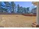 A large backyard enclosed by a wooden fence and tall trees, providing privacy and a natural backdrop at 227 Lantana Dr, Locust Grove, GA 30248