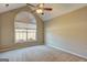 A well lit bedroom featuring neutral walls, carpet flooring and a large window at 227 Lantana Dr, Locust Grove, GA 30248