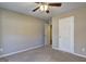 This is an empty bedroom with neutral paint color and a door leading to the bathroom at 227 Lantana Dr, Locust Grove, GA 30248