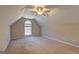 Cozy bedroom with arched window, carpeting, and sloped ceilings at 227 Lantana Dr, Locust Grove, GA 30248